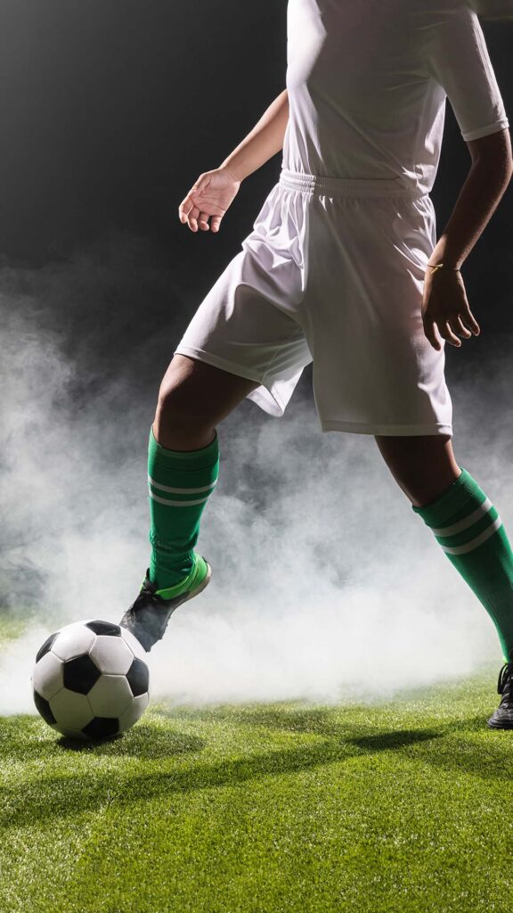 fit woman playing with soccer ball